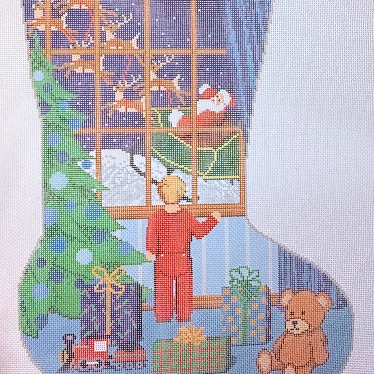 Boy looking out window at Santa